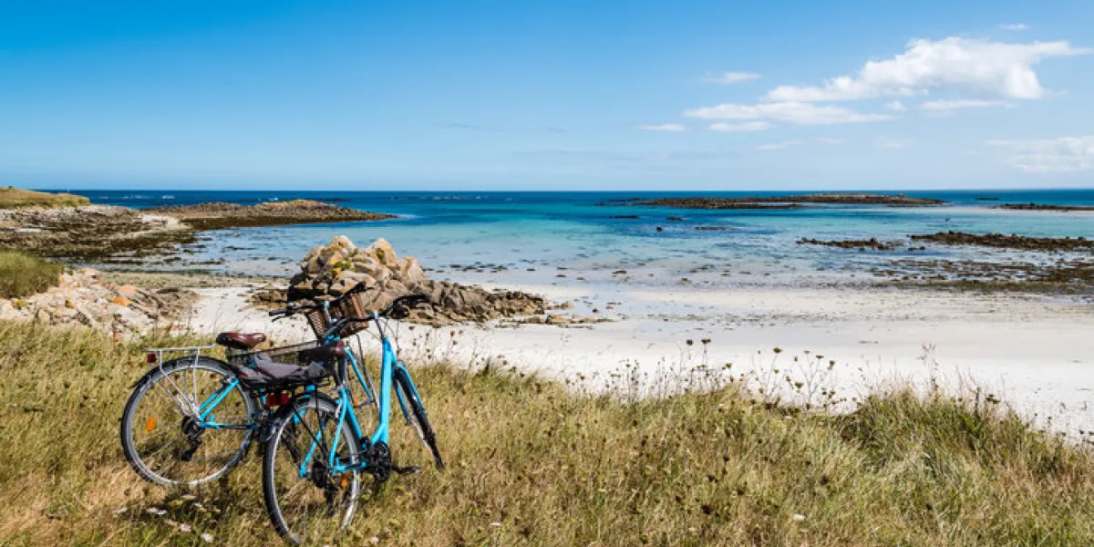 bicycles parked against the beach in the island of batz with no people summer adventure bicycles parked against the beach in the island of batz with no people summer adventure