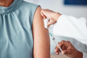 hands, medical and doctor with patient for vaccine in a clinic for healthcare treatment for prevention closeup of a nurse doing a vaccination injection with a needle syringe in a medicare hospital