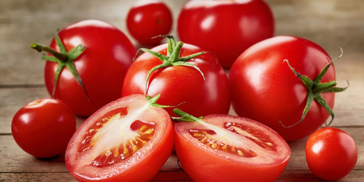 fresh red tomatoes on wooden table