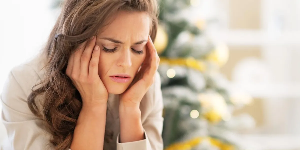 portrait de jeune femme stressée près de sapin de noël