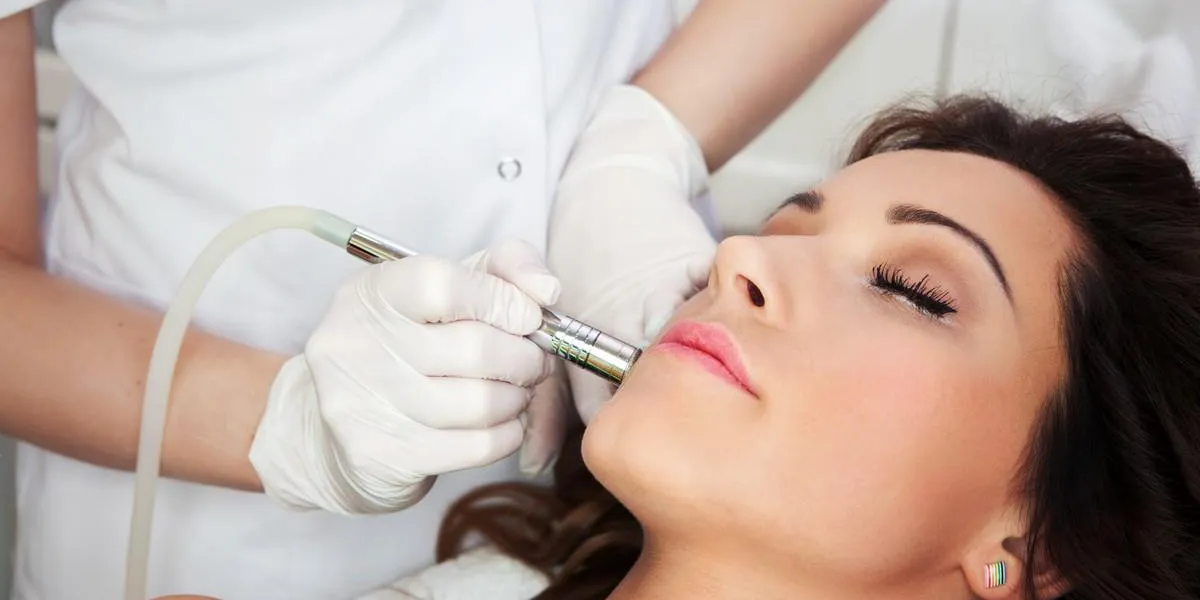 woman getting laser face treatment in medical spa center woman getting laser face treatment in medical spa center