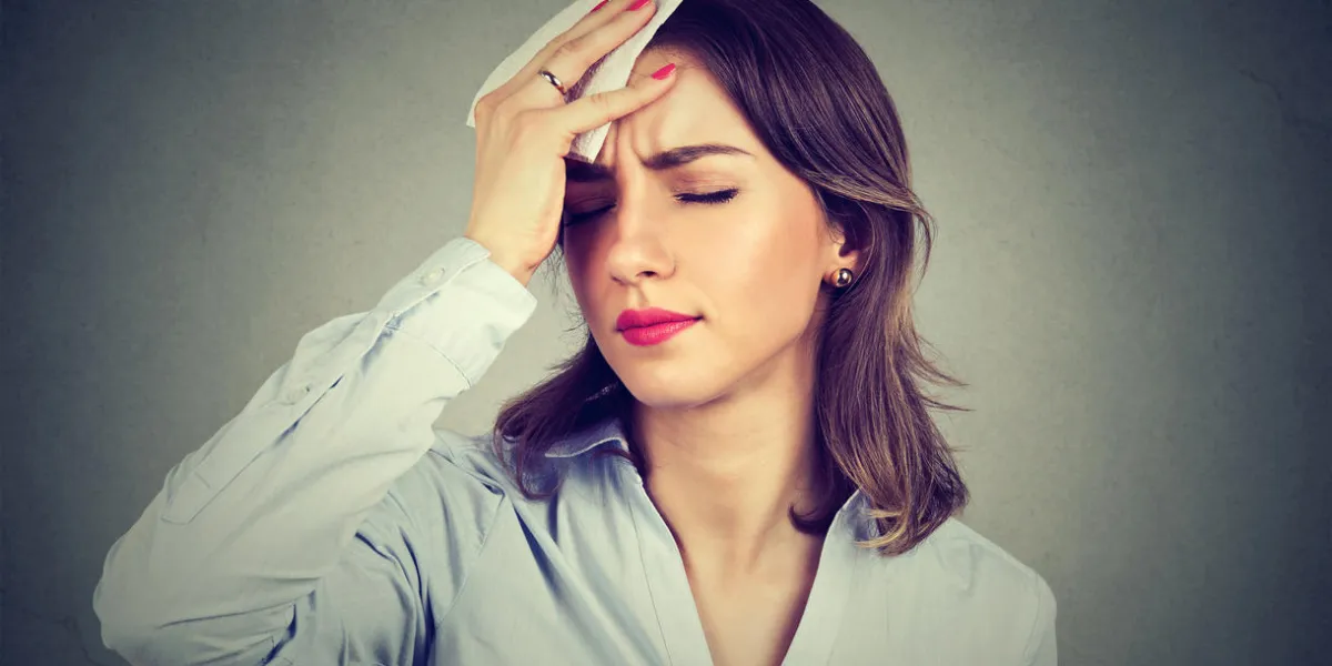 young woman wipes sweat from her forehead with a handkerchief young woman wipes sweat from her forehead with a handkerchief
