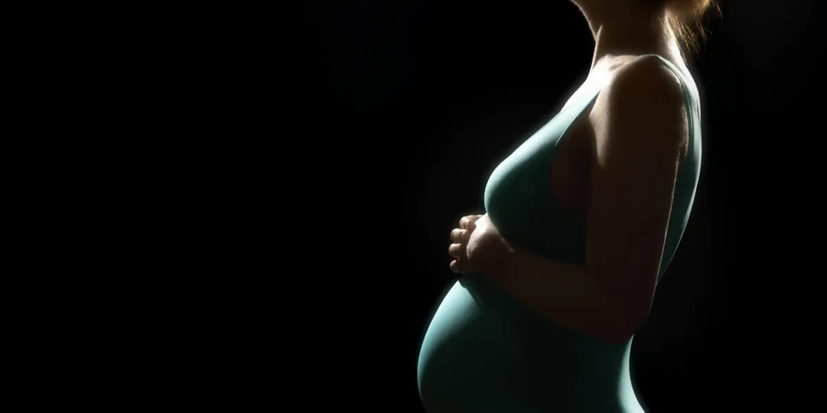 silhouette of pregnant woman on black isolated background