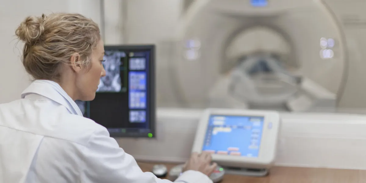doctor operating ct scanner in hospital
