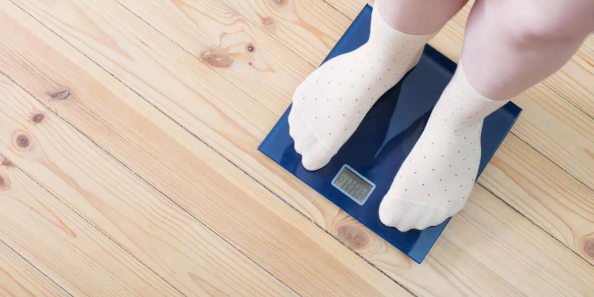 female feet in socks on the floor scales