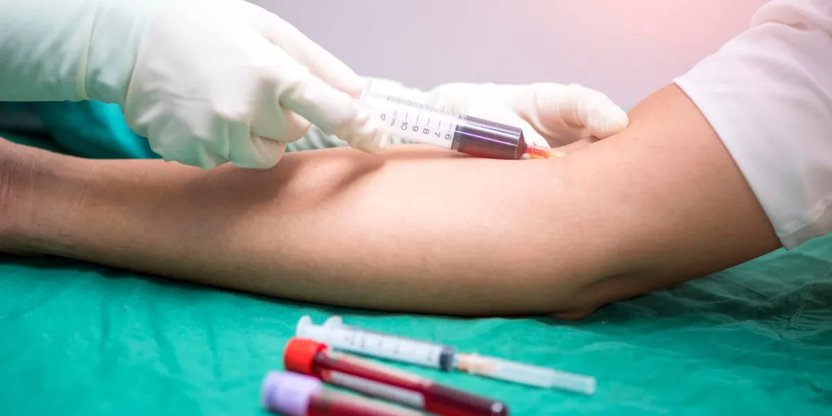 nurse collecting a blood from a patient
