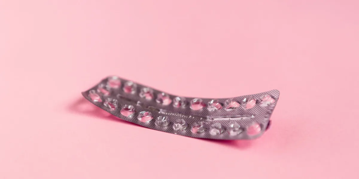 empty strip of birth control pills on pink background empty strip of birth control pills on pink background
