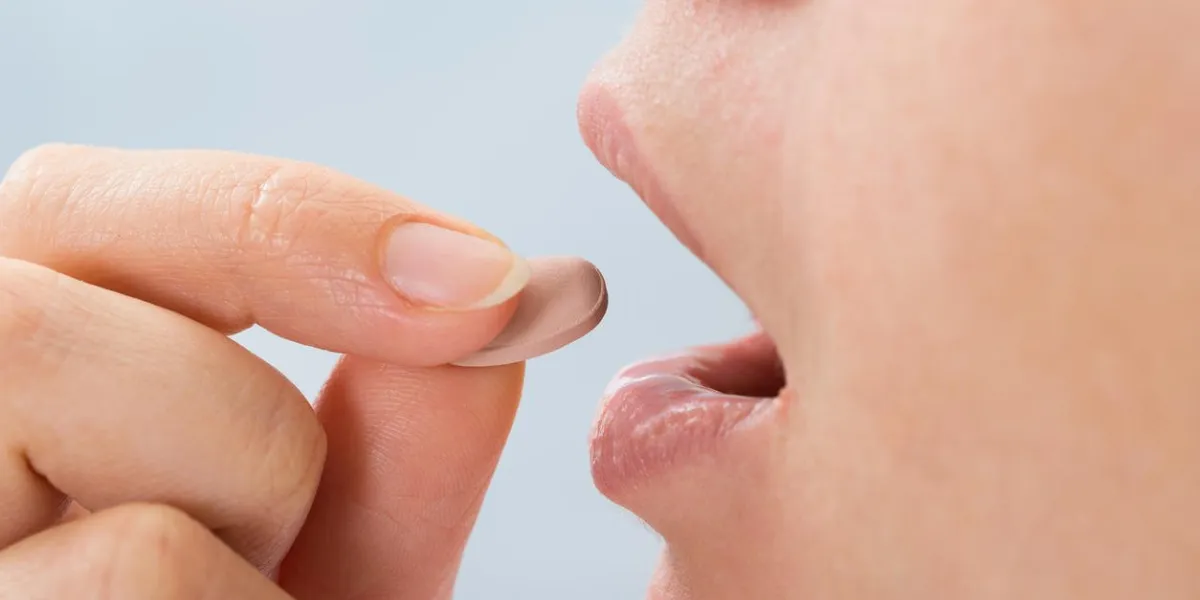 close-up photo of person taking medicine pill close-up photo of person taking medicine pill