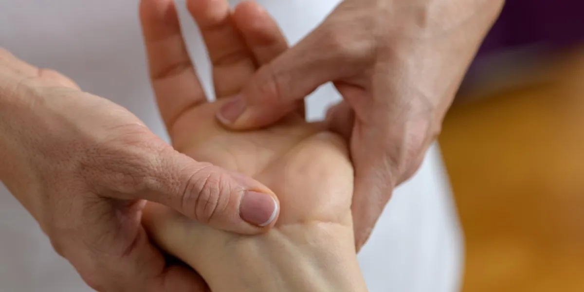 close up photo of a hand of a 30-35 years old caucasian woman lying on a massage table and getting hand and foot massage and special acupressure treatment in health spa close up photo of a hand of a 30-35 years old caucasian woman lying on a massage table and getting hand and foot massage and special acupressure treatment in health spa