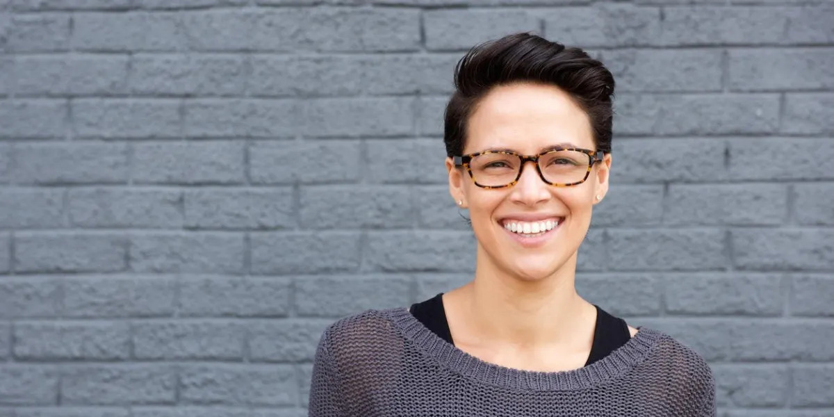 close up portrait of an attractive young woman smiling with glasses
