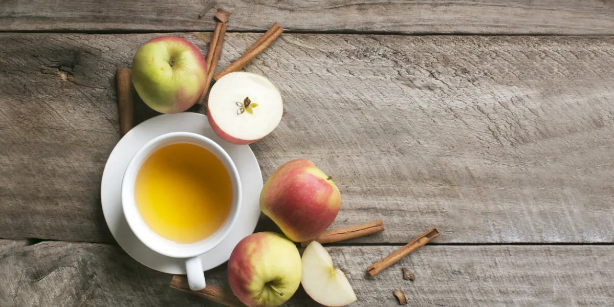 flat lay of a cup of apple cinnamon tea on rustic wooden background copy space image flat lay of a cup of apple cinnamon tea on rustic wooden background copy space image