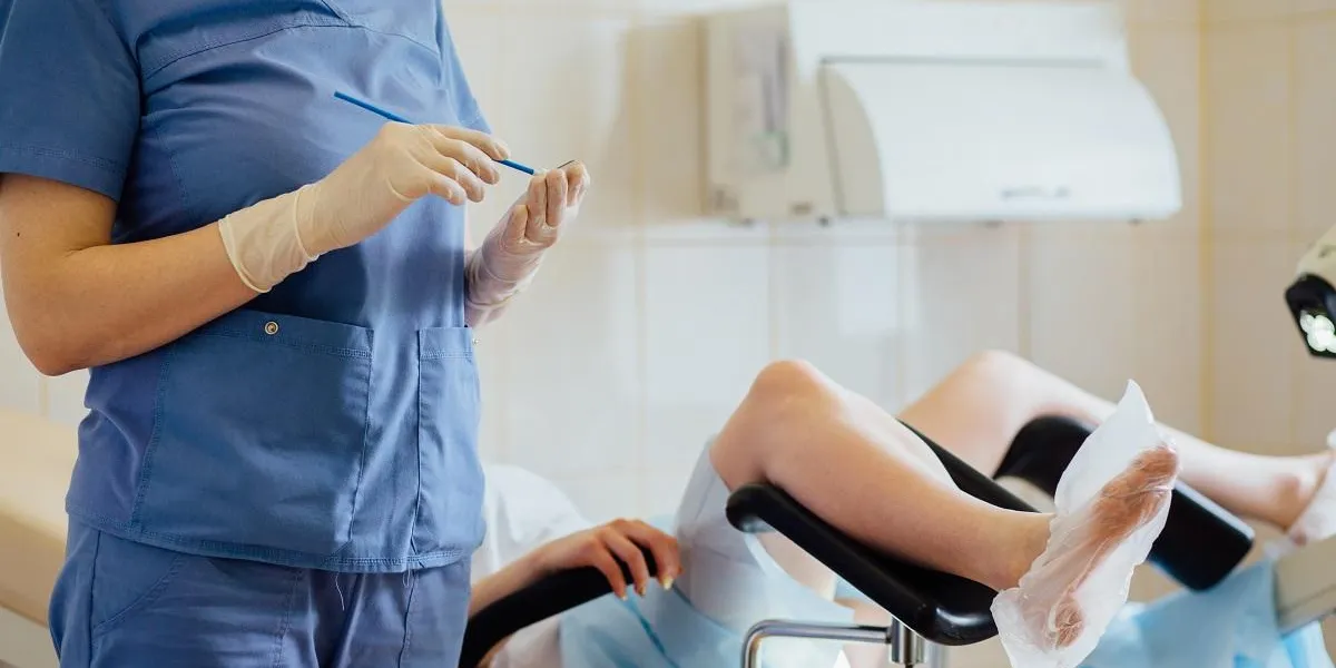 unrecognizable female doctor gynecologist working with patient vaginal smear
