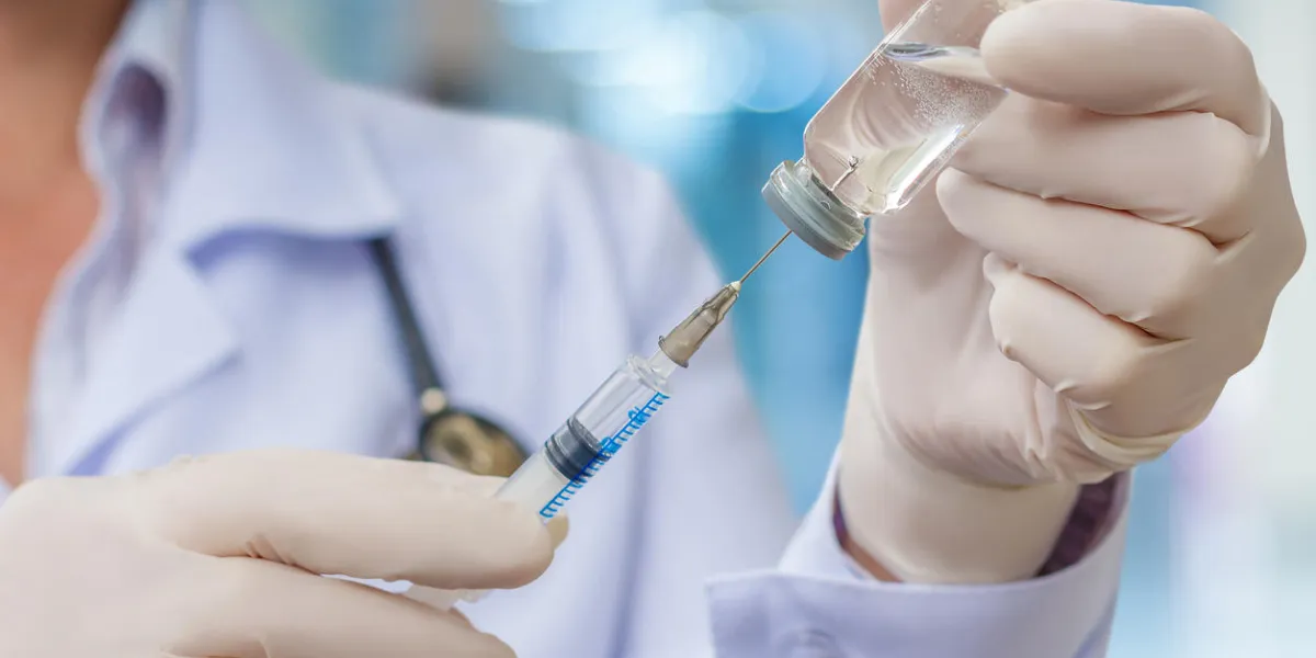 doctor gaining in a syringe medication for injection
