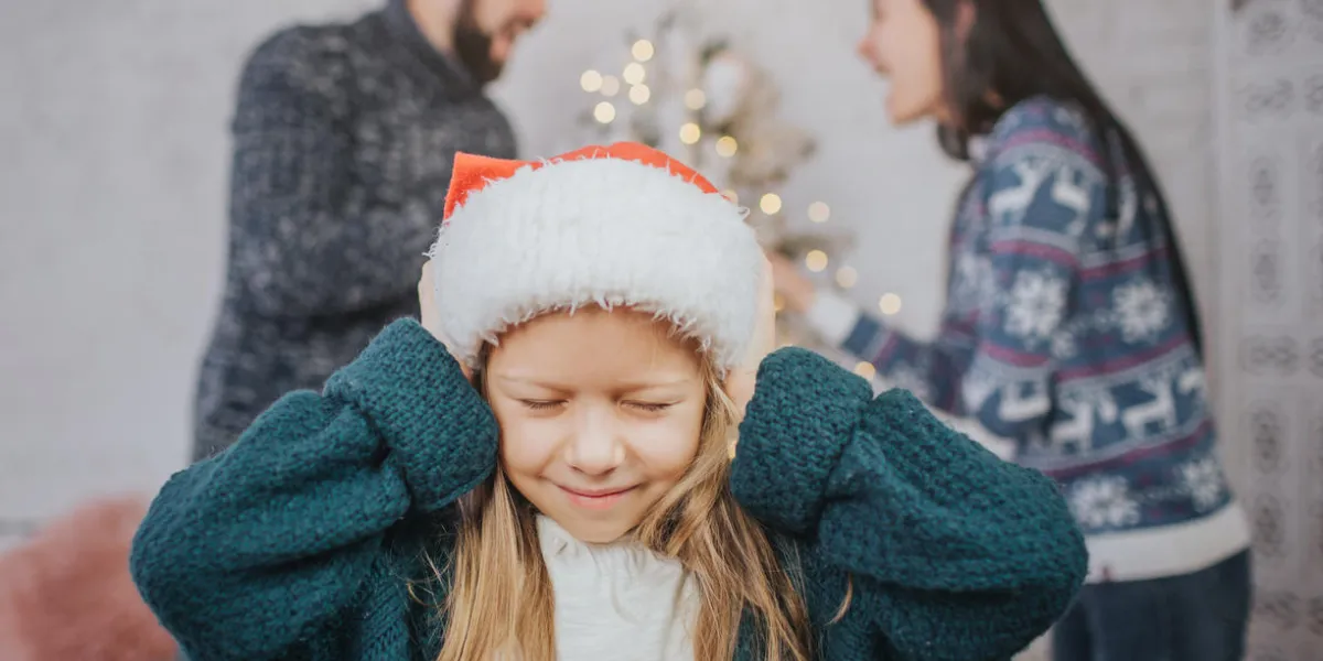 sad, desperate little girl during parents quarrel clog the ears family quarrel on the eve of christmas sad, desperate little girl during parents quarrel clog the ears family quarrel on the eve of christmas