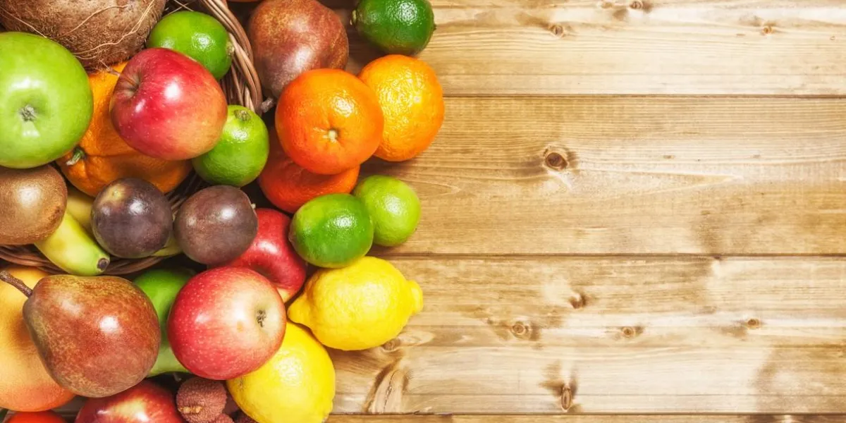 basket of fruits on wooden background healthy eating and dieting concept winter assortment copy space top view
