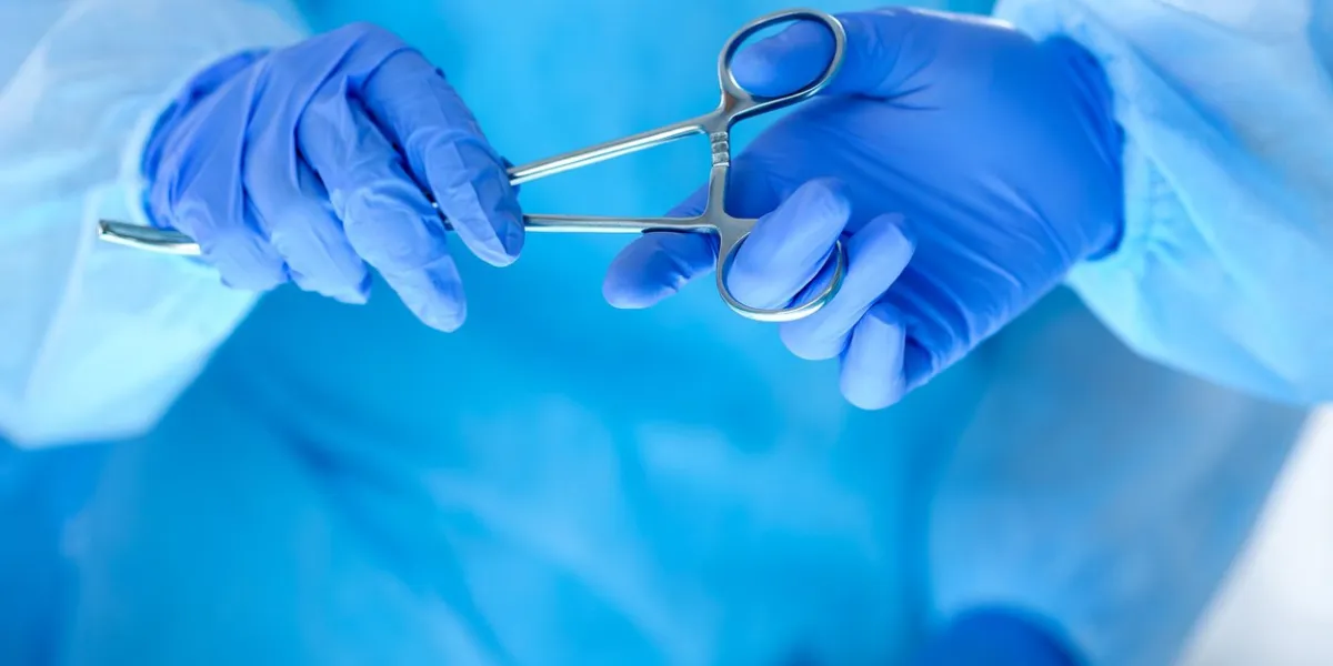 surgeons hands holding and passing surgical instrument to other doctor while operating patient resuscitation medicine team holding steel medical tools saving patient surgery and emergency concept