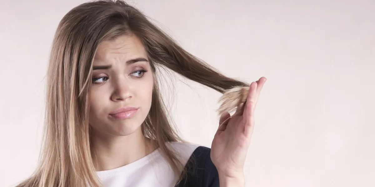 portrait of a frustrated young brunette woman with a split hair portrait of a frustrated young brunette woman with a split hair