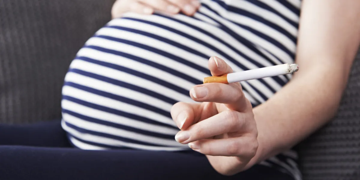 close up of pregnant woman smoking cigarette close up of pregnant woman smoking cigarette