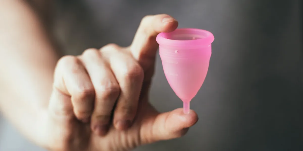 young woman hand holding menstrual cup selective focus and shallow dof young woman hand holding menstrual cup selective focus and shallow dof