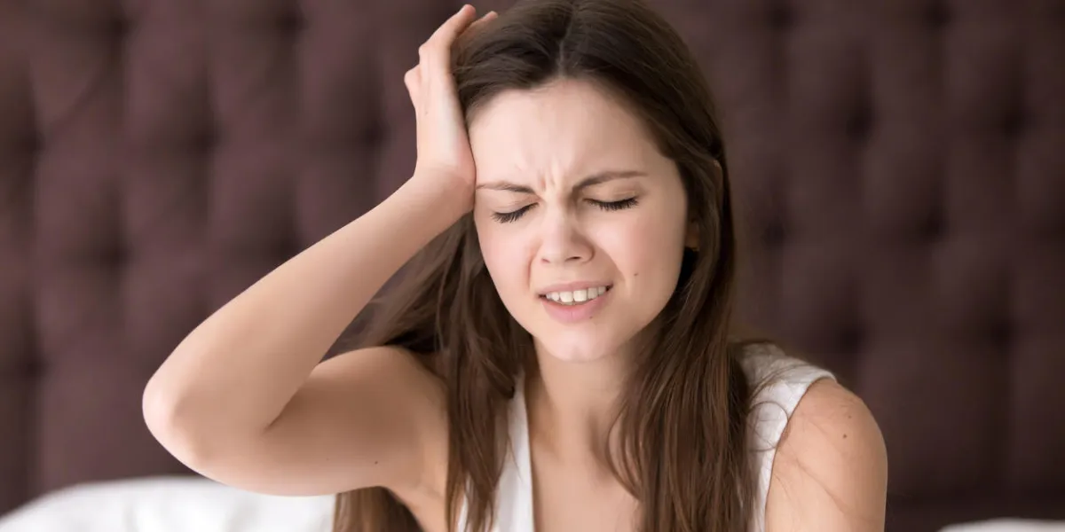 young woman suffering from headache or migraine after wake up in morning stressed lady in bed with painful face expression feels terrible hangover, sharp pain in head, unpleasant weakness, dizziness young woman suffering from headache or migraine after wake up in morning stressed lady in bed with painful face expression feels terrible hangover, sharp pain in head, unpleasant weakness, dizziness