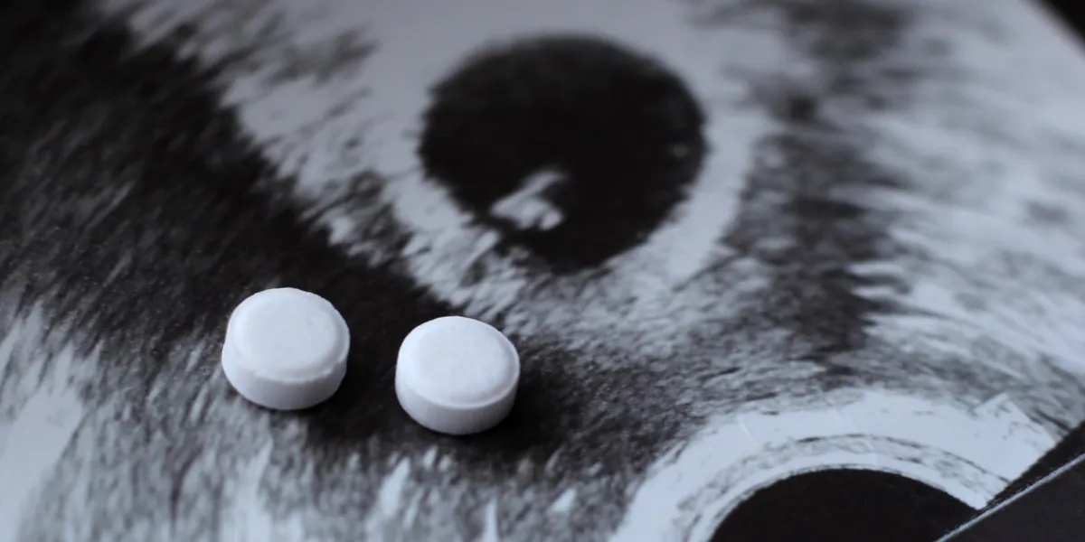 ultrasound of a pregnant woman and pills medication so close