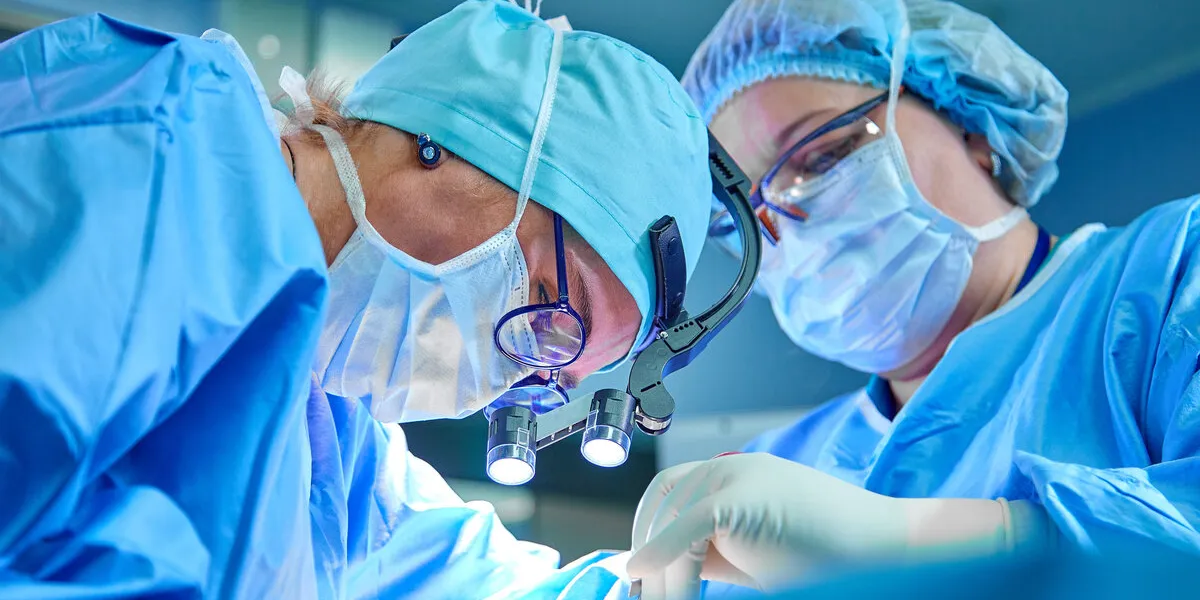 a surgeon's team in uniform performs an operation on a patient at a cardiac surgery clinic modern medicine, a professional team of surgeons, health a surgeon's team in uniform performs an operation on a patient at a cardiac surgery clinic modern medicine, a professional team of surgeons, health