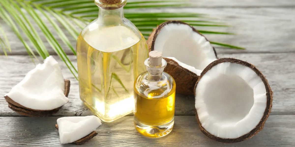 bottles with fresh coconut oil on wooden table bottles with fresh coconut oil on wooden table