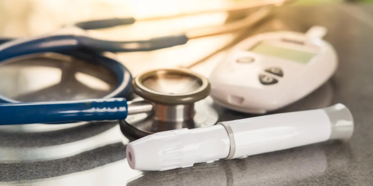 stethoscope and blood glucose meter, lancet on the wooden tablehealthcare medical and check up, diabetes, glycemia, and people concept flat lay