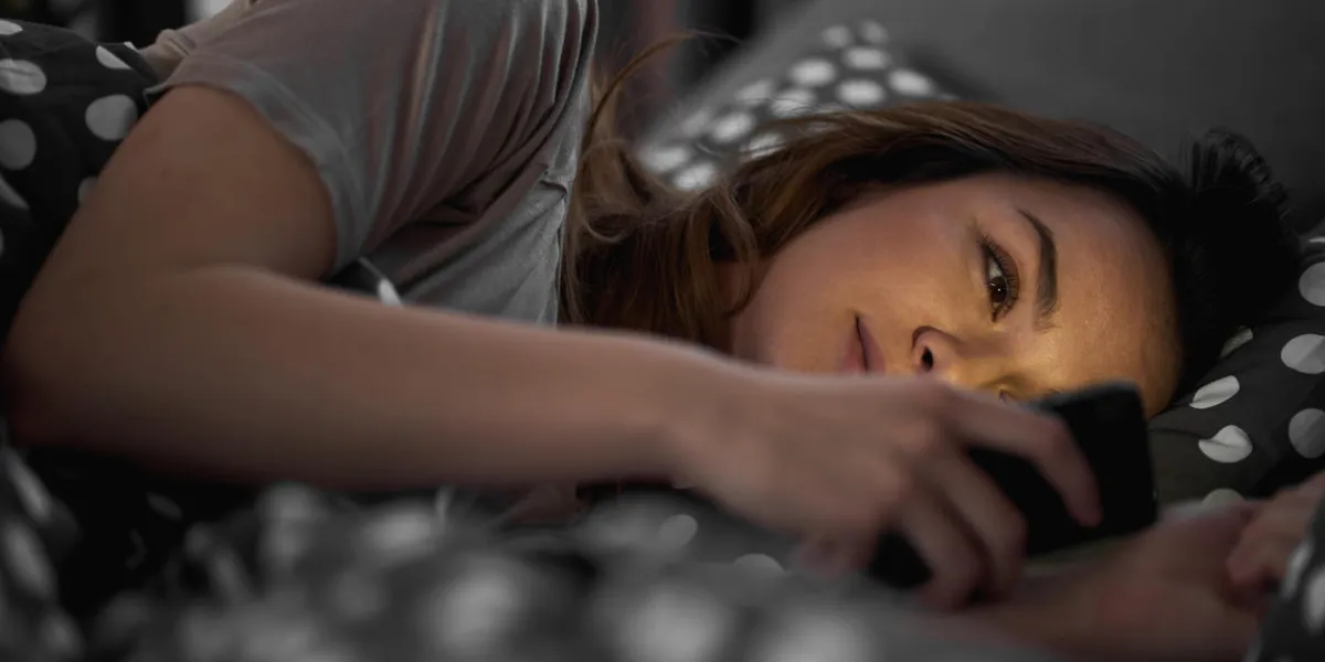girl using smart phone and lying down in bed late at night girl using smart phone and lying down in bed late at night