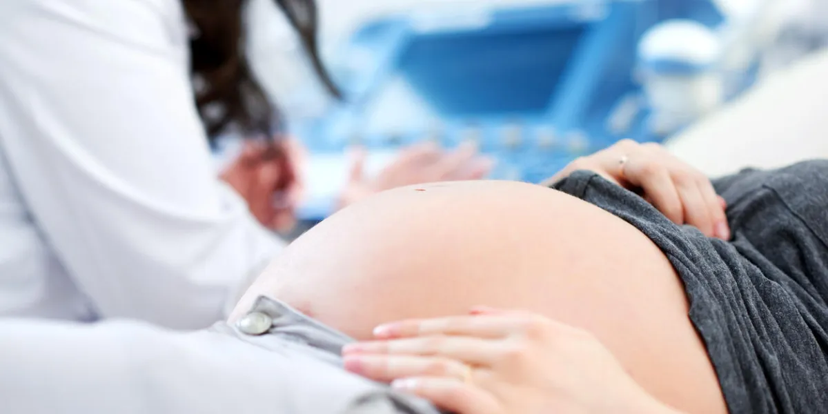 cropped close up of a pregnant woman waiting for her doctor to start ultrasound scanning procedure at the hospital copyspace pregnancy expecting mother children healthcare family gynecology diagnosis