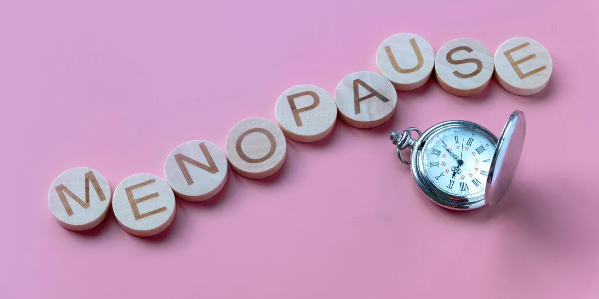 alphabet form a word menopause over a watch healthcare and medical concept for women pink background alphabet form a word menopause over a watch healthcare and medical concept for women pink background