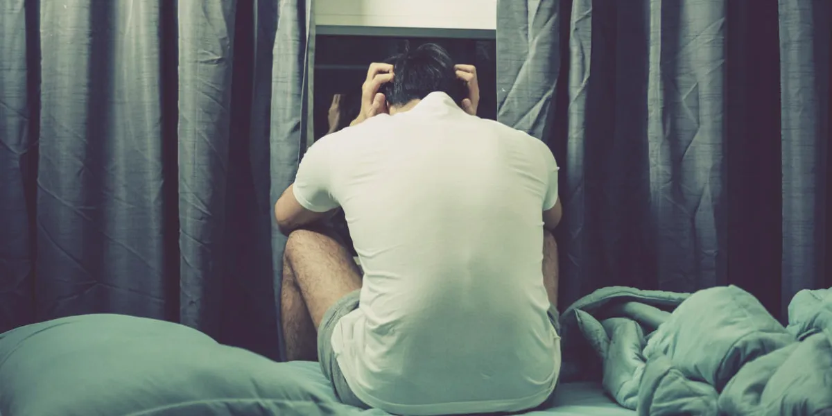 stress and depression concept, man sitting on bed, color filter