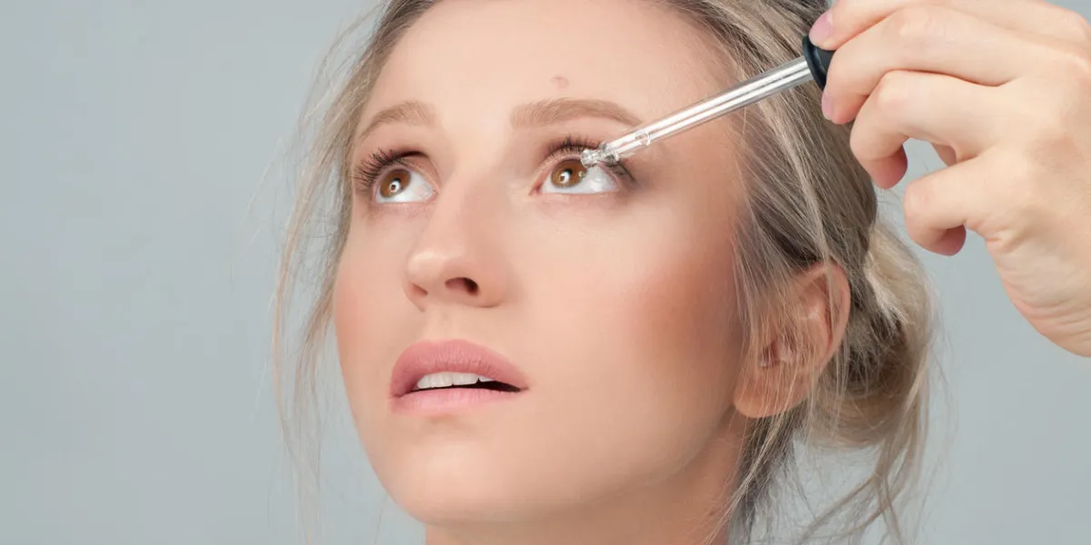 vision and ophthalmology medicine closeup of beautiful woman applying eyedrops in her eyes vision and ophthalmology medicine closeup of beautiful woman applying eyedrops in her eyes