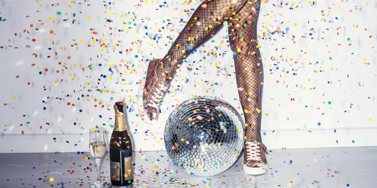 party detail with woman legs in red high heels and disco ball