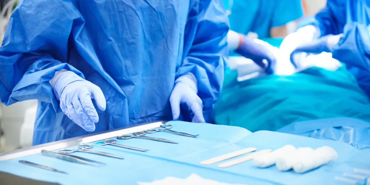 surgeon taking tools from the table surgeon taking tools from the table