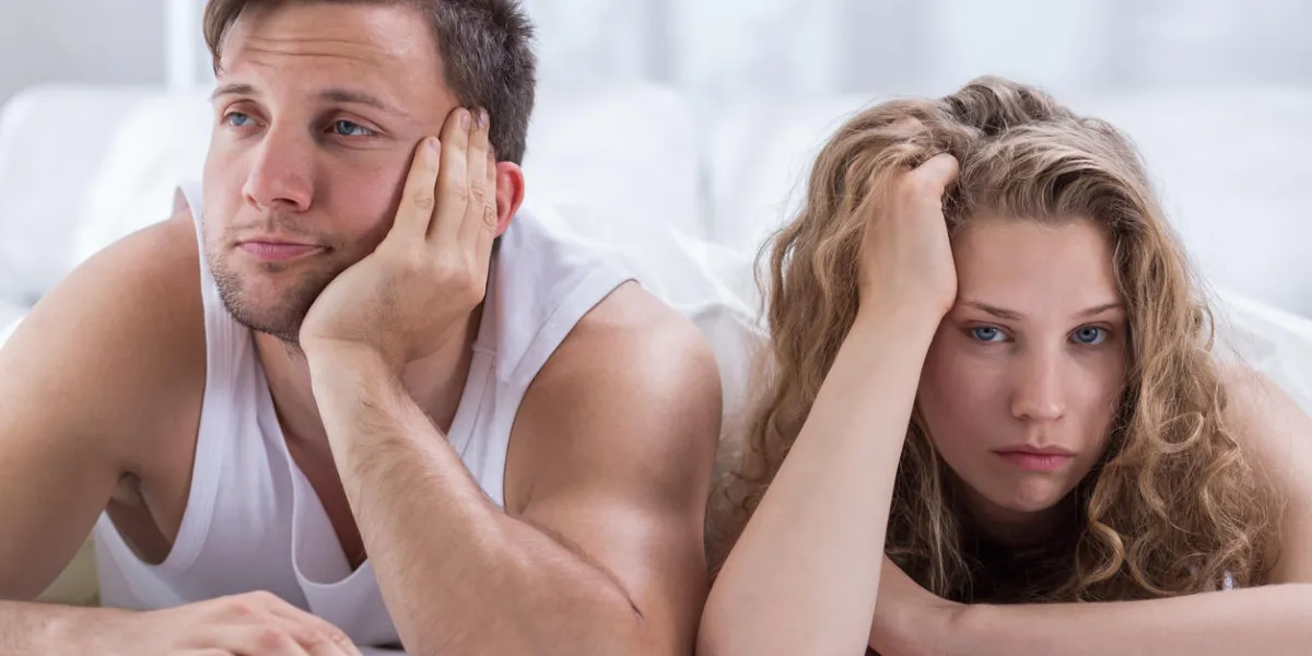 young bored couple having problems in bedroom