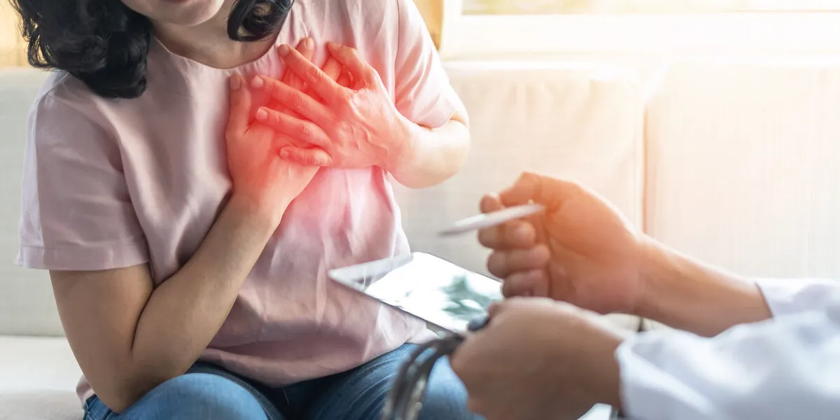 chest pain illness causing heart attck and stroke risk in woman patient with doctor examing and diagnosing patient health in hospital clinic