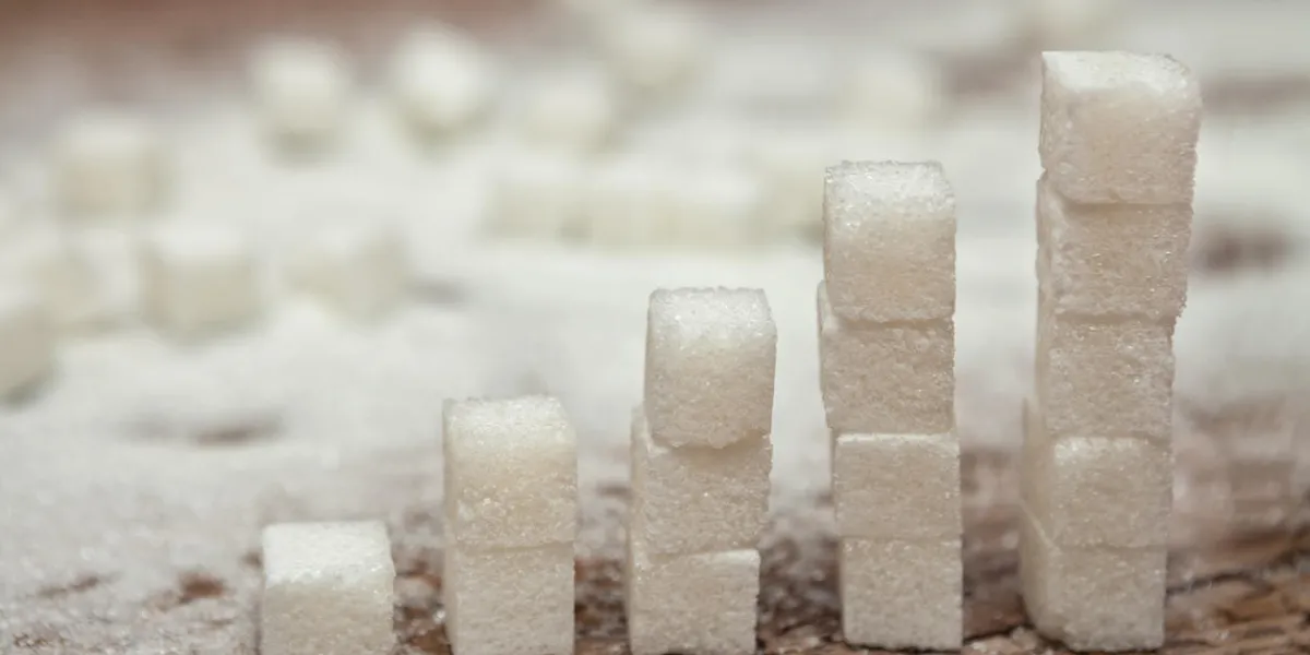 cubes of white sugar on wooden surface, diabetes and high sugar level concept cubes of white sugar on wooden surface, diabetes and high sugar level concept