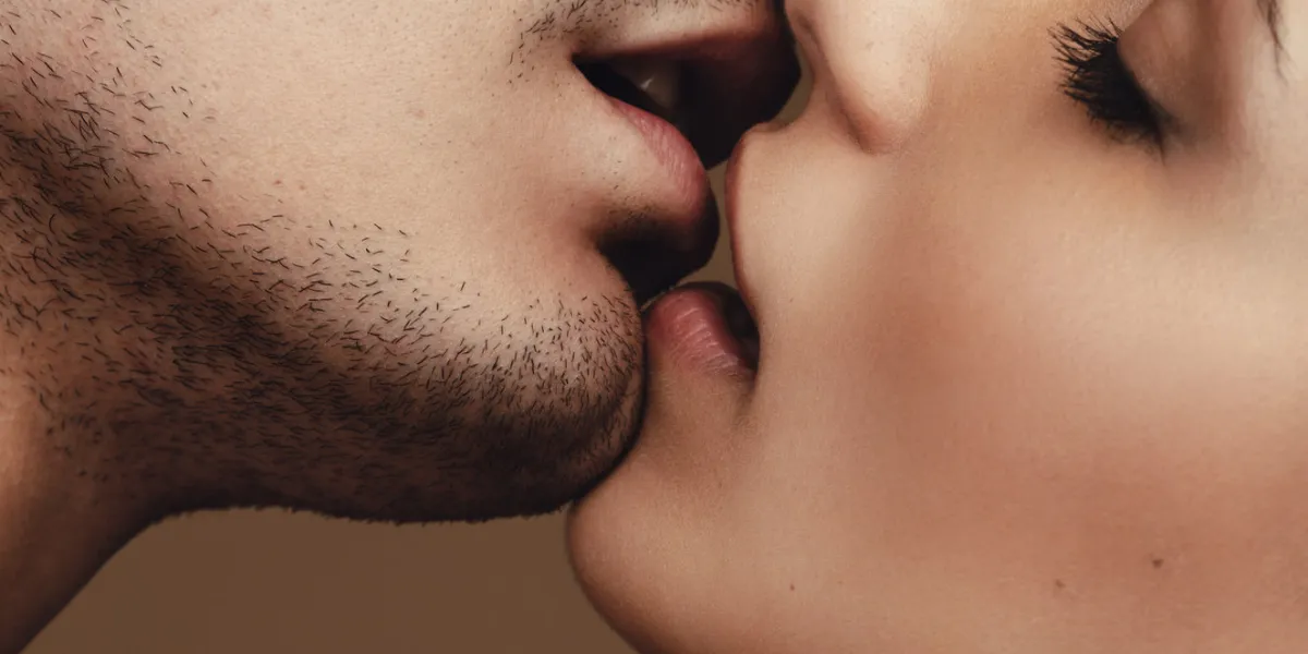 close up of young man and woman kissing close up of a romantic young couple kissing with eyes closed