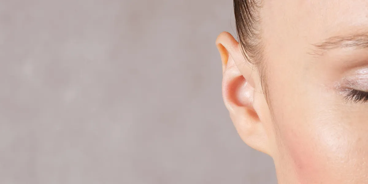 ear of a young caucasian lady between 30 and 40 years old closeup ear of a young caucasian lady between 30 and 40 years old closeup