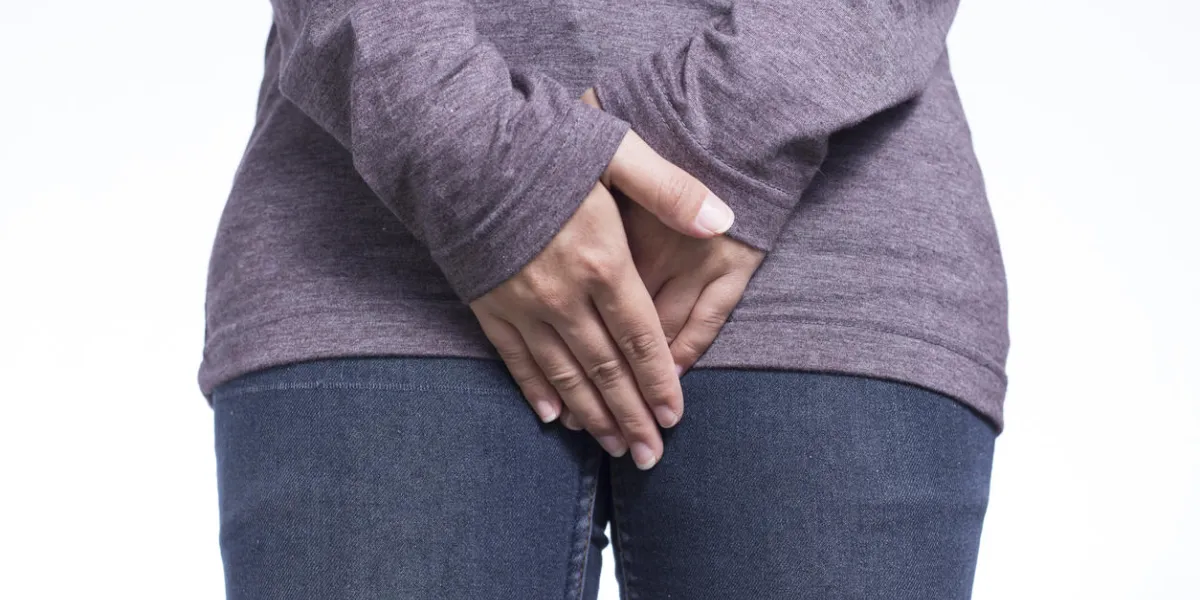 woman with hands holding her crotch woman with hands holding her crotch