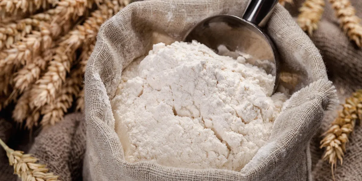 flour in a bag on the table and spikelets flour in a bag on the table and spikelets
