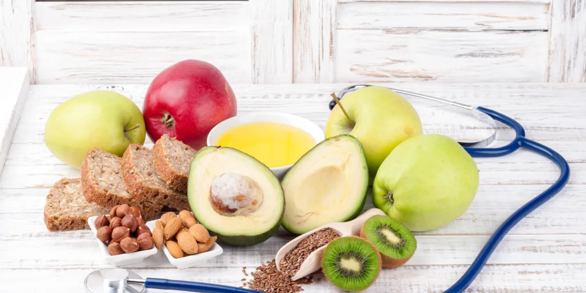 healthy fat sources and healthy food that is good for the heart, stethoscope on wooden background diet and healthy lifestyle concept healthy fat sources and healthy food that is good for the heart, stethoscope on wooden background diet and healthy lifestyle concept