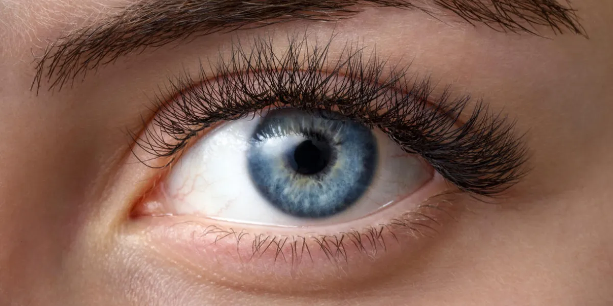 close up photo of woman's blue eye in studio close up photo of woman's blue eye in studio
