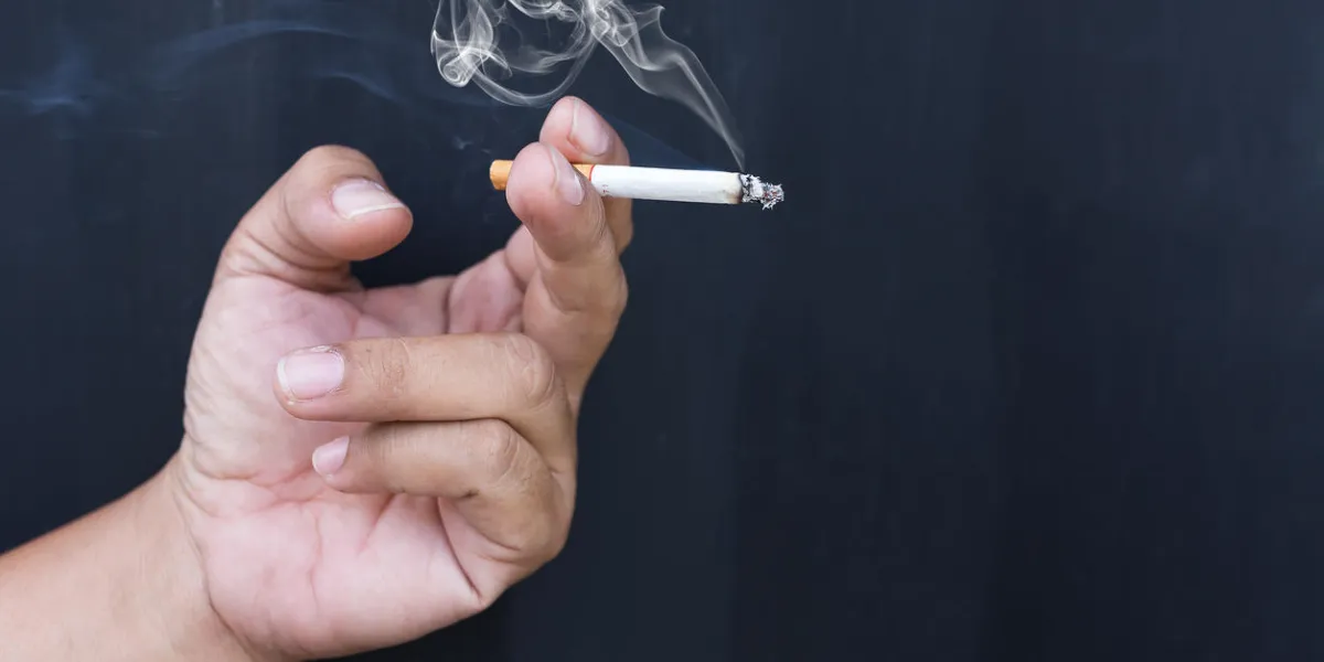 close up cigarette or tobacco with smoke in hand and copy spacen close up cigarette or tobacco with smoke in hand and copy spacen