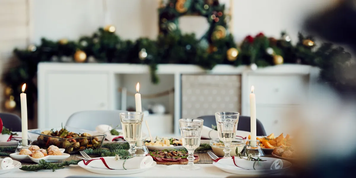 background image of beautiful table setting for christmas party with fir elegant candles and delicious homemade food, copy space
