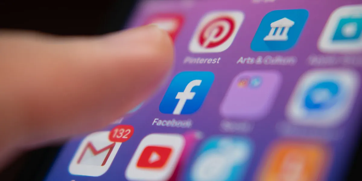 bangkok, thailand - july 13, 2019 iphone user touching facebook logo on iphone screen to open the app bangkok, thailand - july 13, 2019 iphone user touching facebook logo on iphone screen to open the app
