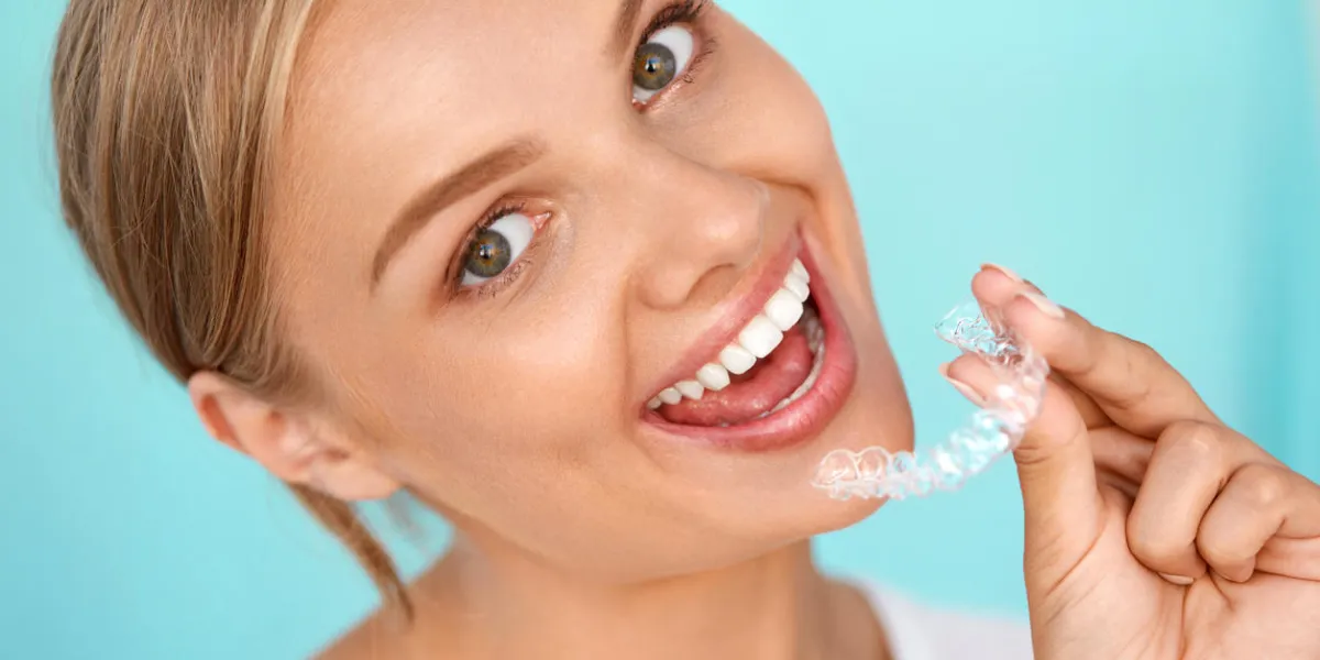 white smile portrait of beautiful smiling woman with healthy straight white teeth holding teeth whitening tray, girl using dental whitener dental beauty treatment concept high resolution image white smile portrait of beautiful smiling woman with healthy straight white teeth holding teeth whitening tray, girl using dental whitener dental beauty treatment concept high resolution image