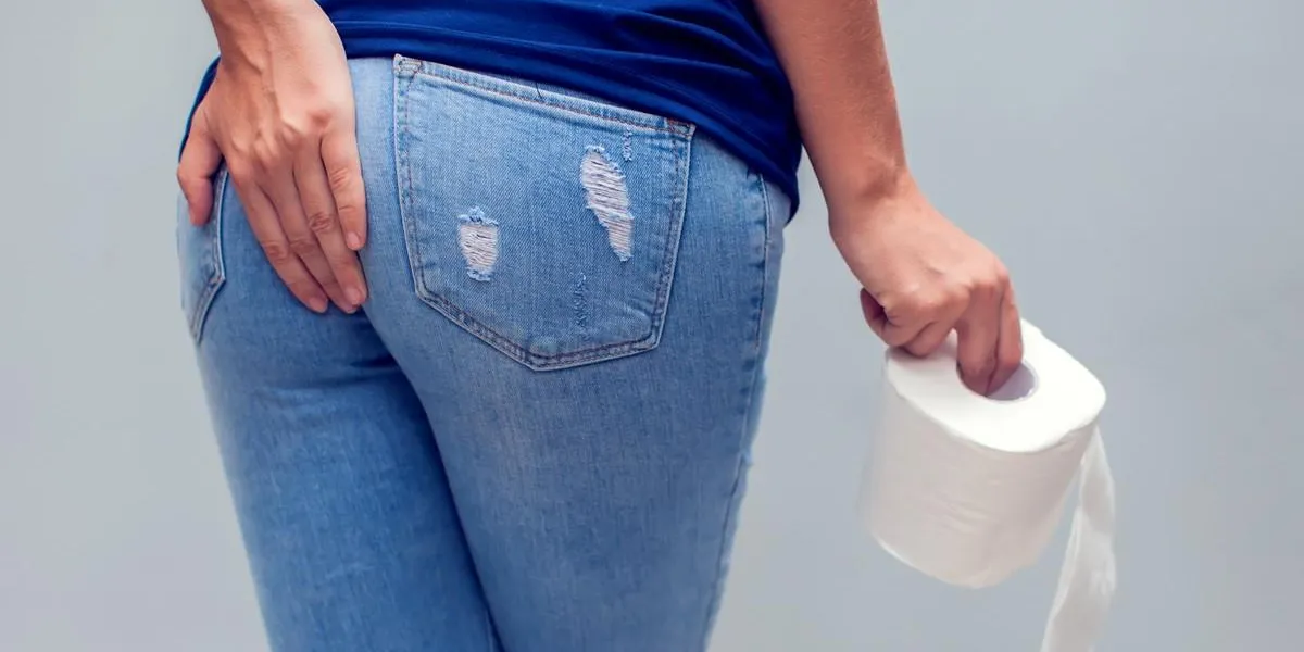 woman suffers from diarrhea holds toilet paper roll stomach upset healthcare concept woman suffers from diarrhea holds toilet paper roll stomach upset healthcare concept