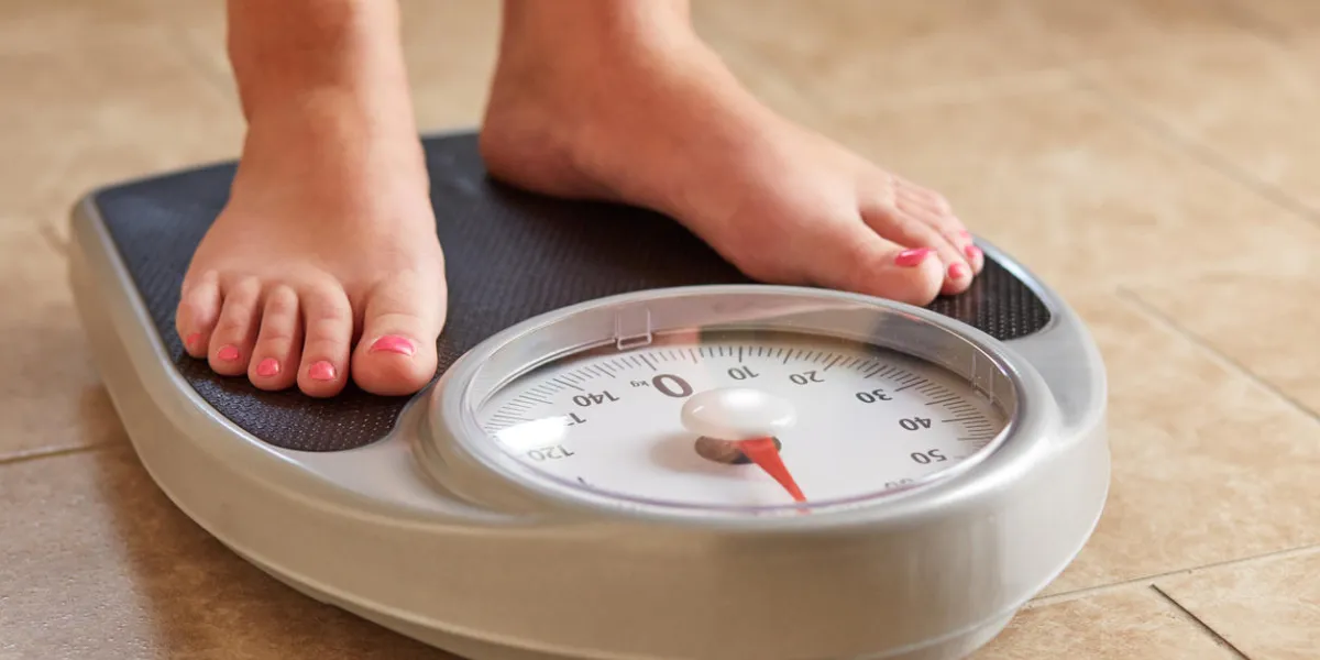 a pair of female feet on a bathroom scale